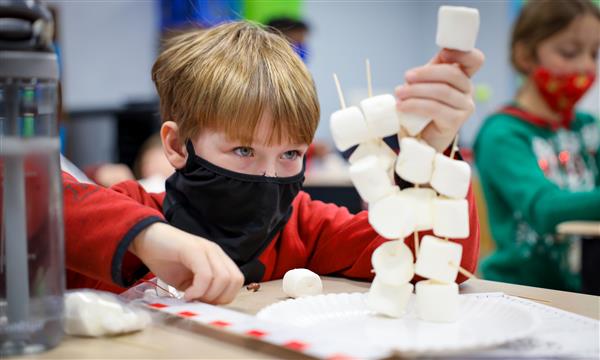 Boy builds marshmallow tower